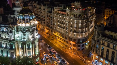 Madrid, Spain - September 21: Zoom out time lapse view of landmark buildings and traffic on Gran Via street at night in Madrid, the capital and largest city in Spain. 