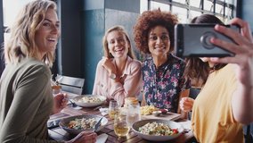 Four Female Friends Posing For Selfie In Restaurant Before Eating Meal - Powered by Shutterstock - Get 15% off with code: PIKWIZARD15
