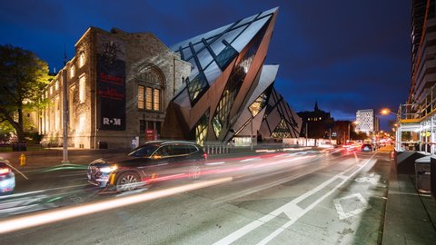 Toronto, Canada - October 25, 2018: Time lapse view of traffic in front of the Royal Ontario Museum (ROM), the largest and most-visited museum in Canada, at dusk in Toronto, Ontario, Canada. 