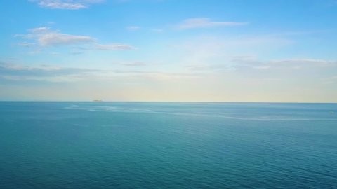 Aerial view Video of calming waves of the Thai Sea/Ocean during a warm sunny morning with a blue cloudless sky at Kho Samet.Thailand