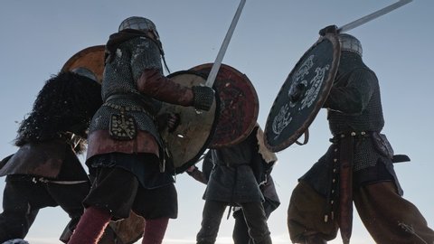 Warriors of vikings are fighting during attack at winter time.
