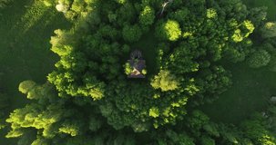 4K high quality early summer sunny afternoon aerial video footage of abandoned village site with ruins of old vintage church in the middle of dense green wild woods in Russia's Yaroslavl region