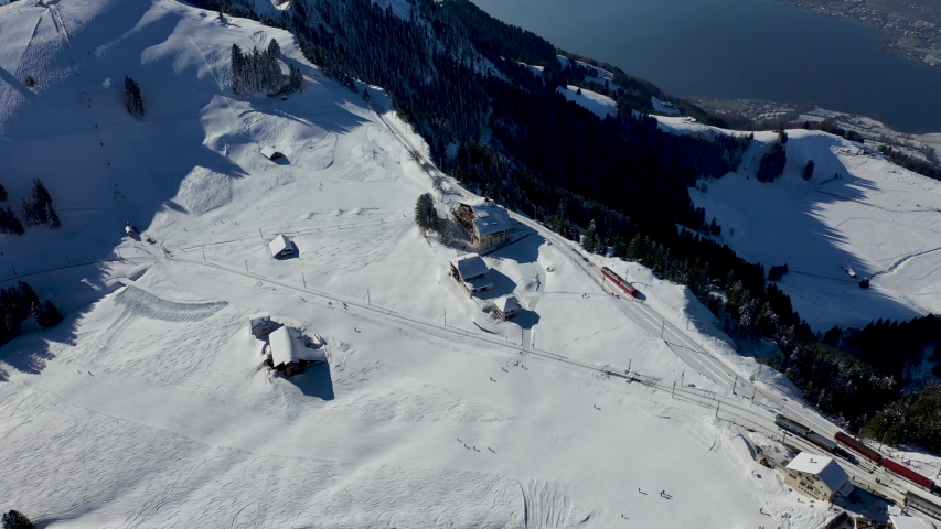 Birds eye view of a restaurant on mount Rigi on a beautiful winter day ( 4K aerial footage). 