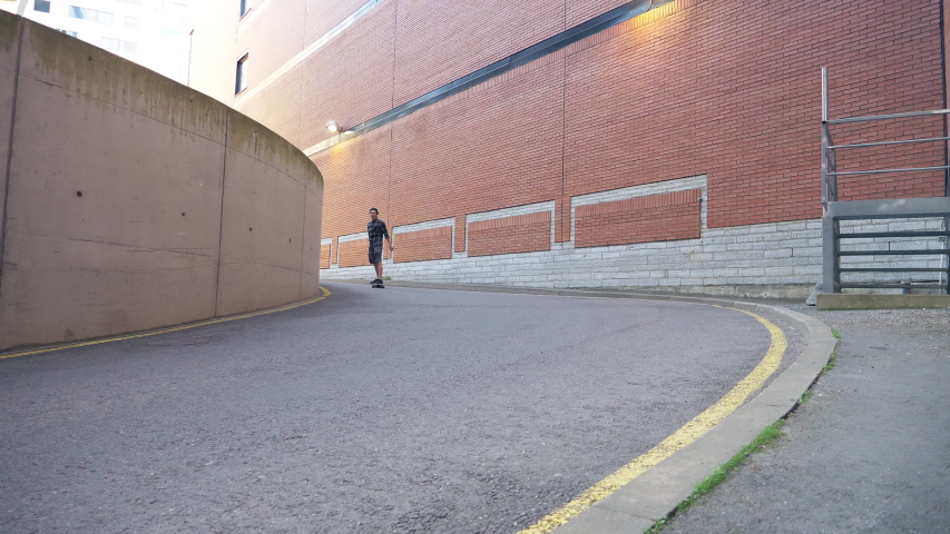 Man Riding Down From Hill on Skate Board. Urban City Part