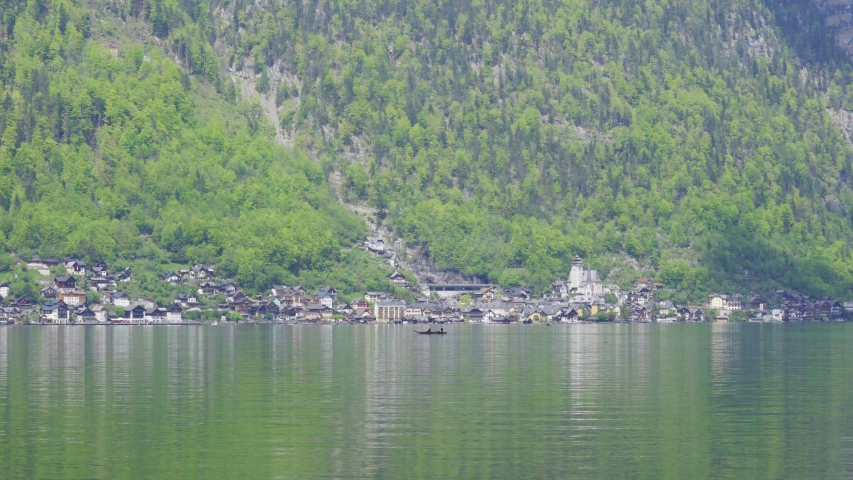 Beautiful little town of Halstatt - latest attraction for tourists from all over the world. View from the other side of the Halstatt See (lake). 