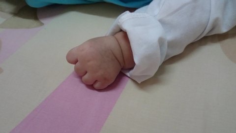 Hand of a baby with hiccup sound 