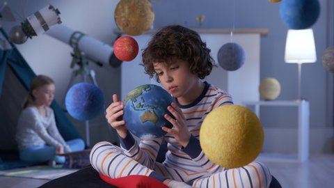 Portrait of Playful Creative Spaceman. Small Person at Modern Night Playground for Fly to Space Closeup. Inspiration Activity of Dreamer in Family Room. Sad Adorable Human and Global Ecosystem Problem
