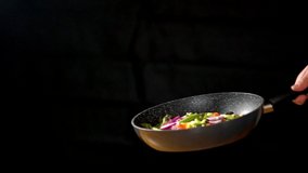 MCU: Saucepan tossing stir fry vegetables in slow motion in studio - Powered by Shutterstock - Get 15% off with code: PIKWIZARD15