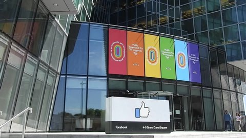 1st July 2019, Dublin, Ireland. Facebook's European headquarters building in Dublin's Grand Canal Dock with the LGBTQ Pride colours above the entrance. People in the background.
