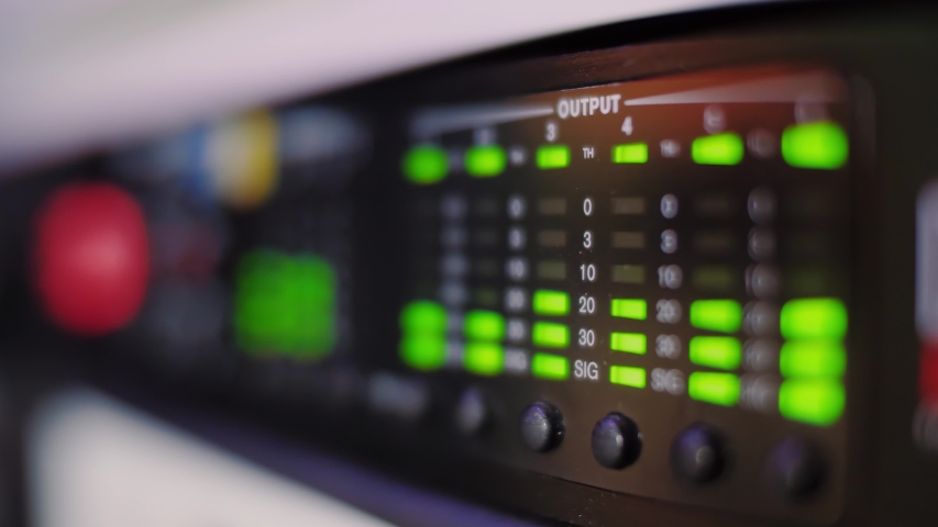 Audio equalizer bars moving on electronic panel, music control levels on desk, close up. Blurred bokeh background. | Shutterstock HD Video #1032406106