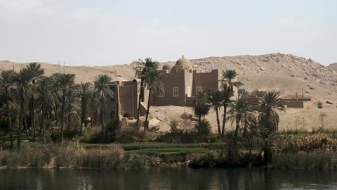 View of Beautiful Egyptian village from a Nile river cruise. Nile Cruise on a cruise ship in Egypt from Aswan to Luxor travel in Egypt, Africa