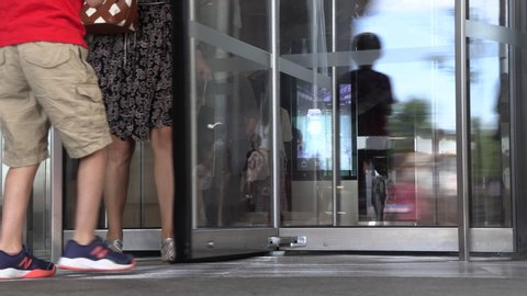 New York City, USA - June 5, 2019 - People entering and exiting through revolving doors