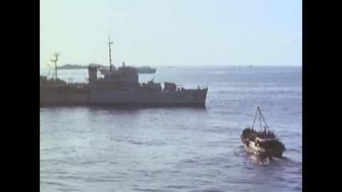 CIRCA 1970s - South Vietnamese evacuees and soldiers are shown aboard a boat as well as cargo ships in a harbor.