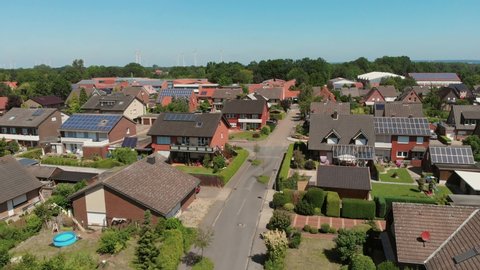 The span of the camera over the roofs of a small German city. Flying camera over the roofs with solar panels. Greven, Germany. Aerial view 4K