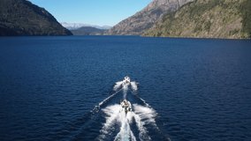 Drone aerial view of two boats with people on Nahuel Huapi Lake in Bariloche, Patagonia Argentina