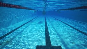 Underwater man swimming in clear sport pool