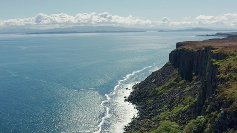AERIAL: Flying along the cliffs towards Kilt Rock on the Isle of Skye, Scotland, UK