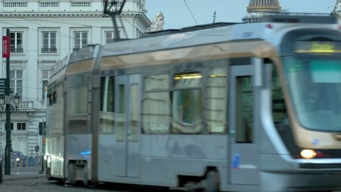 BRUSSELS/BELGIUM - 26TH APRIL 2019: Dawn shot of modern tram on Rue Royale. The Statue of Godfrey of Bouillon and Palais de Justice are in the background