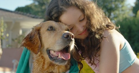 happy girl drying wet dog with towel after swimming in pool child enjoying summer vacation with golden retriever animal friend having fun afternoon at summertime holiday home 4k