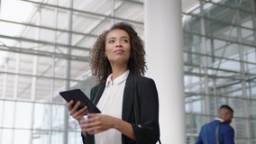beautiful business woman in airport using tablet computer texting walking in corporate office building checking email messages online successful female executive at work 4k - Powered by Shutterstock - Get 15% off with code: PIKWIZARD15