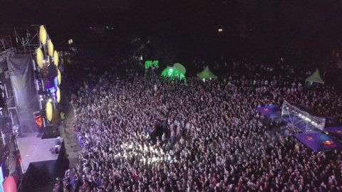 Aerial drone footage of music festival crowd partying to popular edm dj set on dancefloor.EDM music festival event shot from above view flying video camera at night concert gig.KYIV-25 MAY,2019