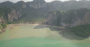 Aerial drone panoramic high angle view panning from Tonsai to Railay to Phranang beaches and karst limestone mountains in Railay, Krabi Province, Thailand