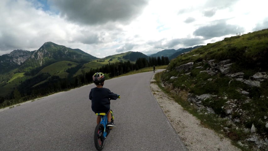 Summer time in the Austrian alps. Mother with son cycling trip.
Beautiful woman and small child are driving through beautiful landscape. Austrian Alpine Cycle Path. Stabilized video. | Shutterstock HD Video #1032472517