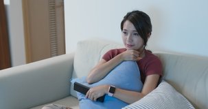 Woman feel tired on watching TV at home