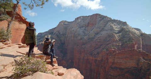 Hikers Sitting on Edge of Canyon, Couple Hiking Zion National Park