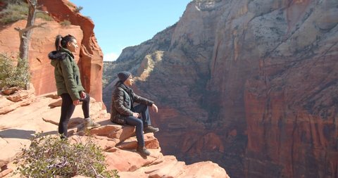 Couple on Edge of Canyon, Hikers in Zion National Park