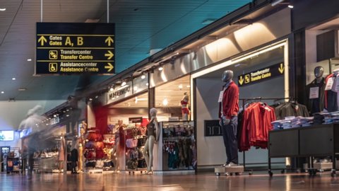 Copenhagen International Airport (CPH), Copenhagen, Denmark - June 2019: Time-lapse of transit passengers passing by shopping zone in Copenhagen International Airport