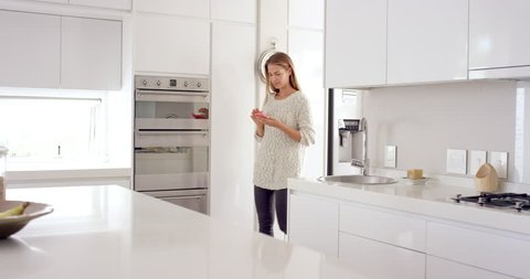 Woman in smart connected home using phone online internet of everything to enjoy a digital lifestyle