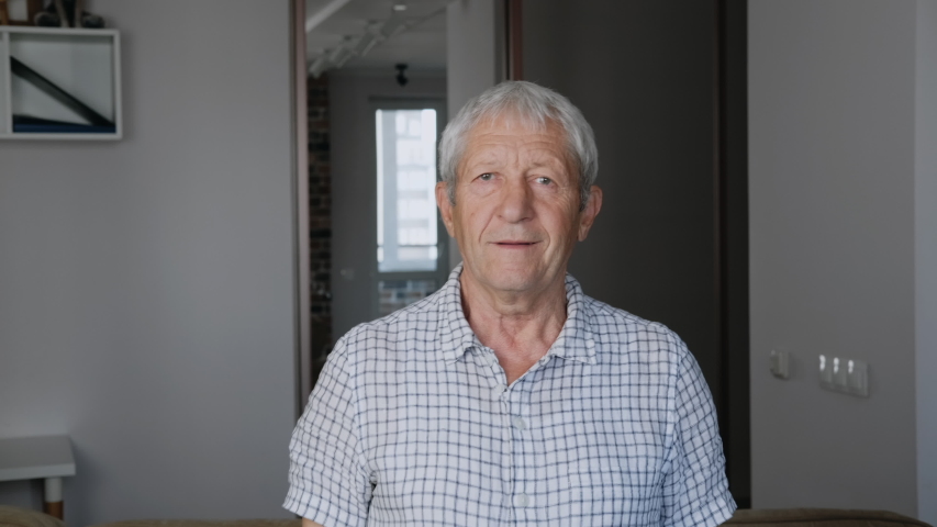 Portrait of an old man pensioner. Old man spends time at home