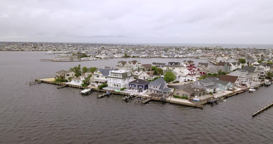 Drone parallax left to right ocean town overcast