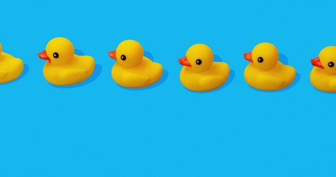 yellow rubber ducks swimming in a close row on blue background stop motion