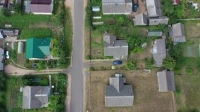 4k video drone flies over the countryside. Roofs and asphalt roads