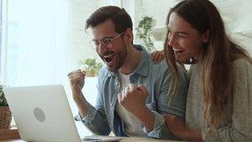 Lucky overjoyed happy young couple using looking at laptop computer excited by online bet bid win feel winners euphoric celebrating by internet lottery victory prize good news got new opportunity - Powered by Shutterstock - Get 15% off with code: PIKWIZARD15