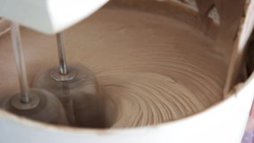 Close up of a food mixer making chocolate cake dough