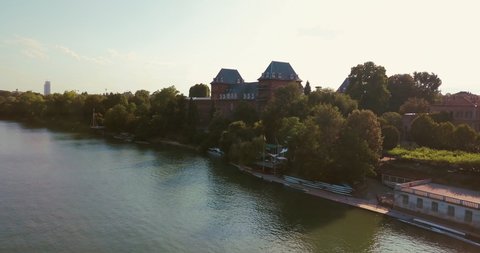 Castello del Valentino by Po river in Turin during sunny afternoon drone shot