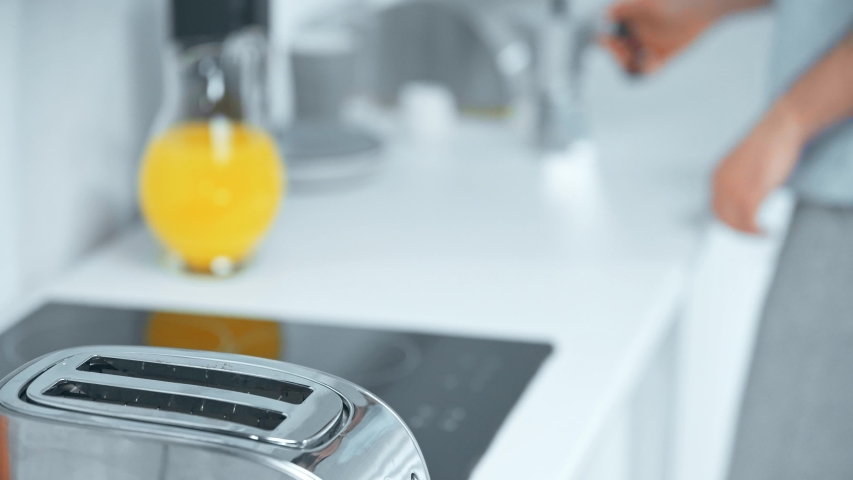 Selective focus of man pouring orange juice and taking tasty bread toasts | Shutterstock HD Video #1032522035