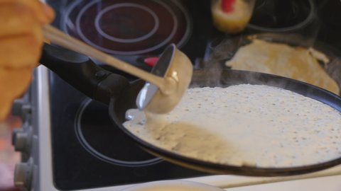 Baking Pancakes On A Frying Pan On Kitchen Stove.
