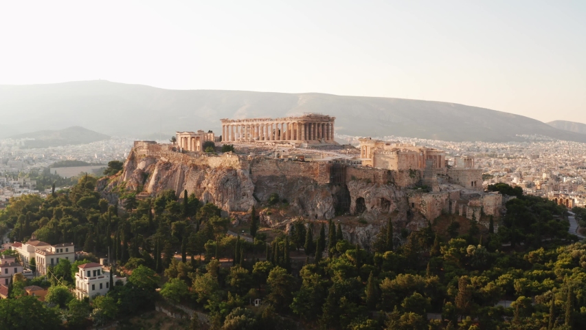Greece Acropolis city of Athens parthenon, symbol of ancient, aerial view slide from drone on panorama of residential buildings at sunrise summer. Lights sun, lens flare. World Heritage sites. History Royalty-Free Stock Footage #1032528281