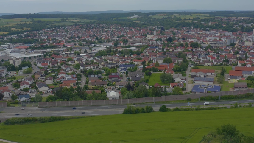 Aerial of Sinsheim and Autobahnn beside it in Germany. Round pan to the left.