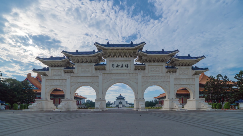 Time lapse of National Chiang Kai shek Memorial Hall in Taipei downtown, Taiwan. A famous monument, landmark and tourist attraction in urban city at noon.