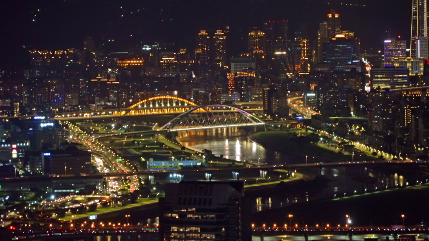Aerial view of Taipei Downtown, Taiwan. Financial district and business centers in smart urban city. Skyscraper and high-rise buildings at night.