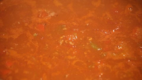 Close in shot of Chili cooking, simmering 