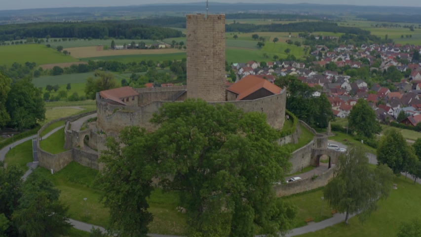 Aerial of the town Weiler beside the castle Steinsberg in Germany. Descending in front of the castle.