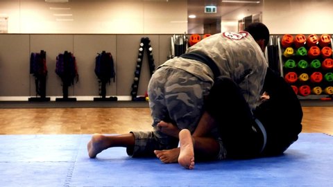 Lisbon, Portugal - July 2, 2019: Two men practice Brazilian Jiu-Jitsu sparring, a grappling type martial arts with a kimono gi - NOT STAGED CONTENT