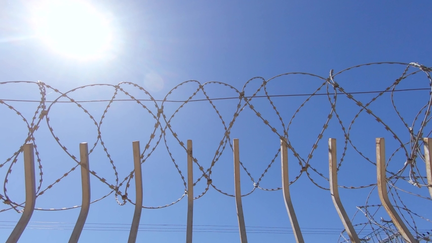 Iron fence and barbed wire over it