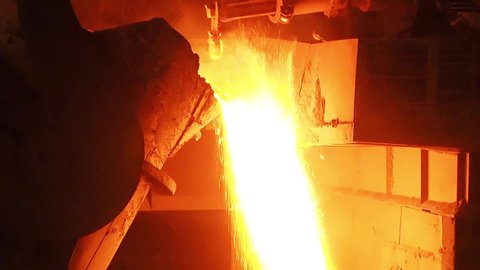 Molten metal in the melting ladle. Removing slag from the melting metal
